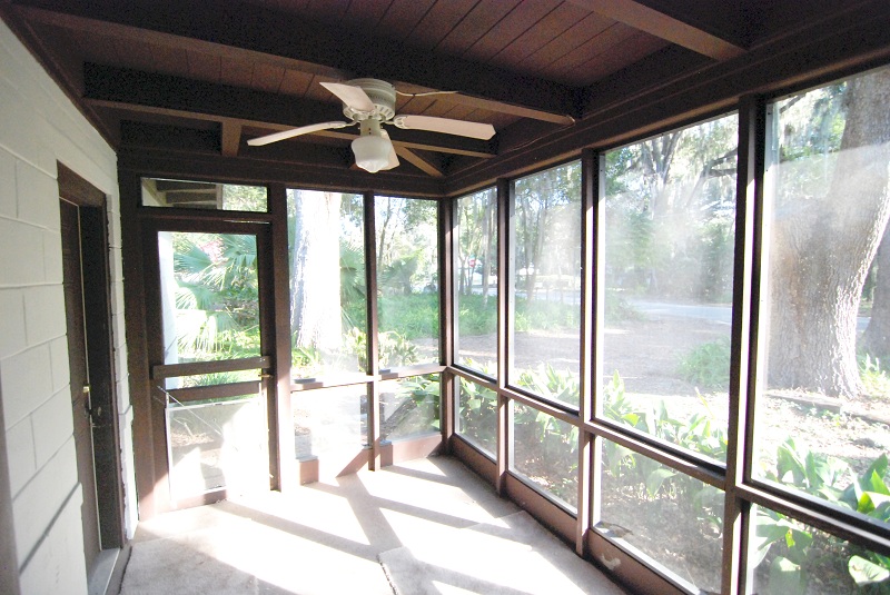 Screened in porch with a view of the spacious front yard