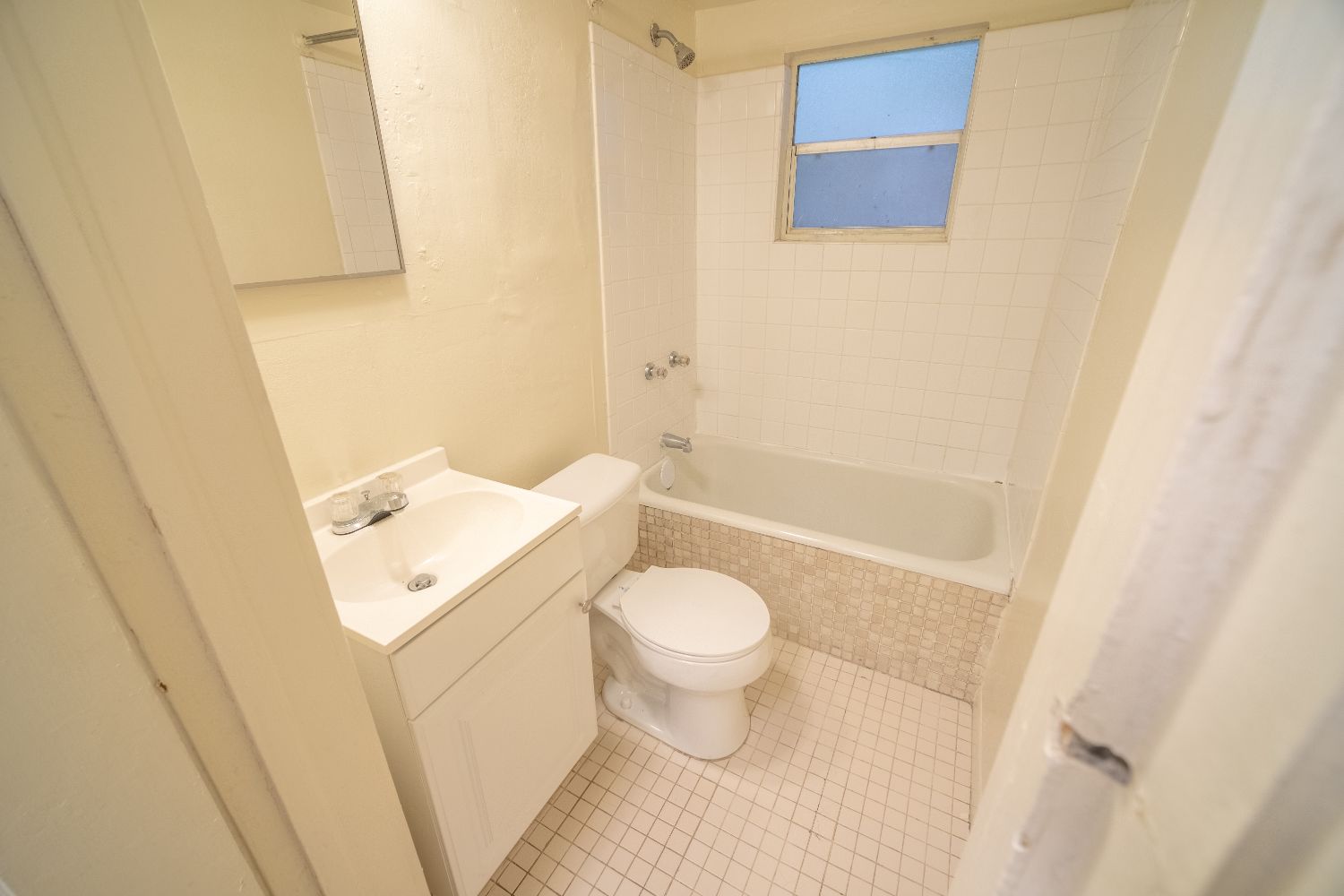 Shared bathroom with tile flooring